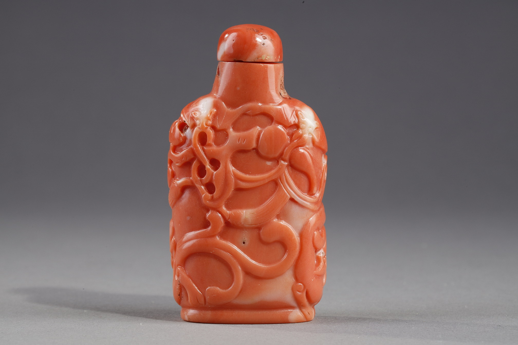 Snuff bottle coral sculpted with bats and two dragons